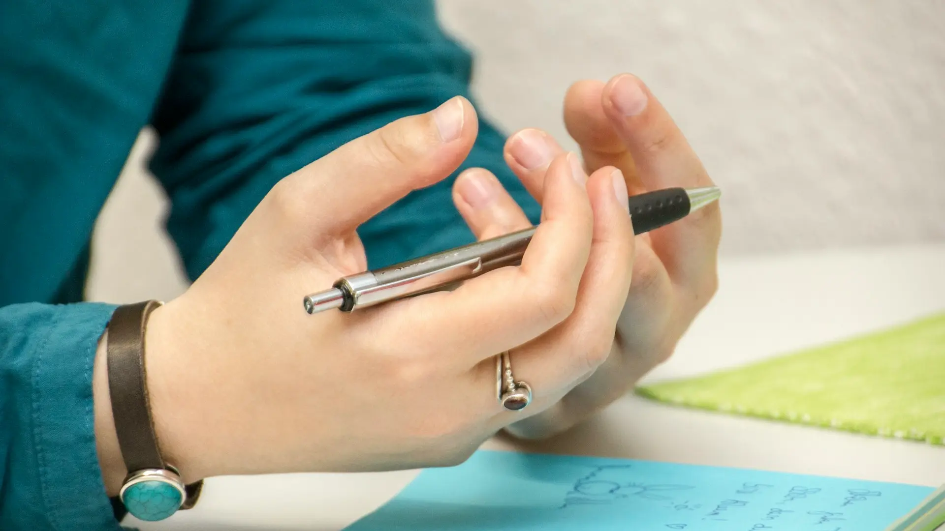 a person sitting at a table using a cell phone